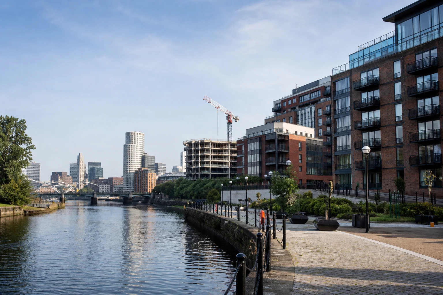 Leeds riverside regeneration with modern mixed-use buildings and city-centre skyline