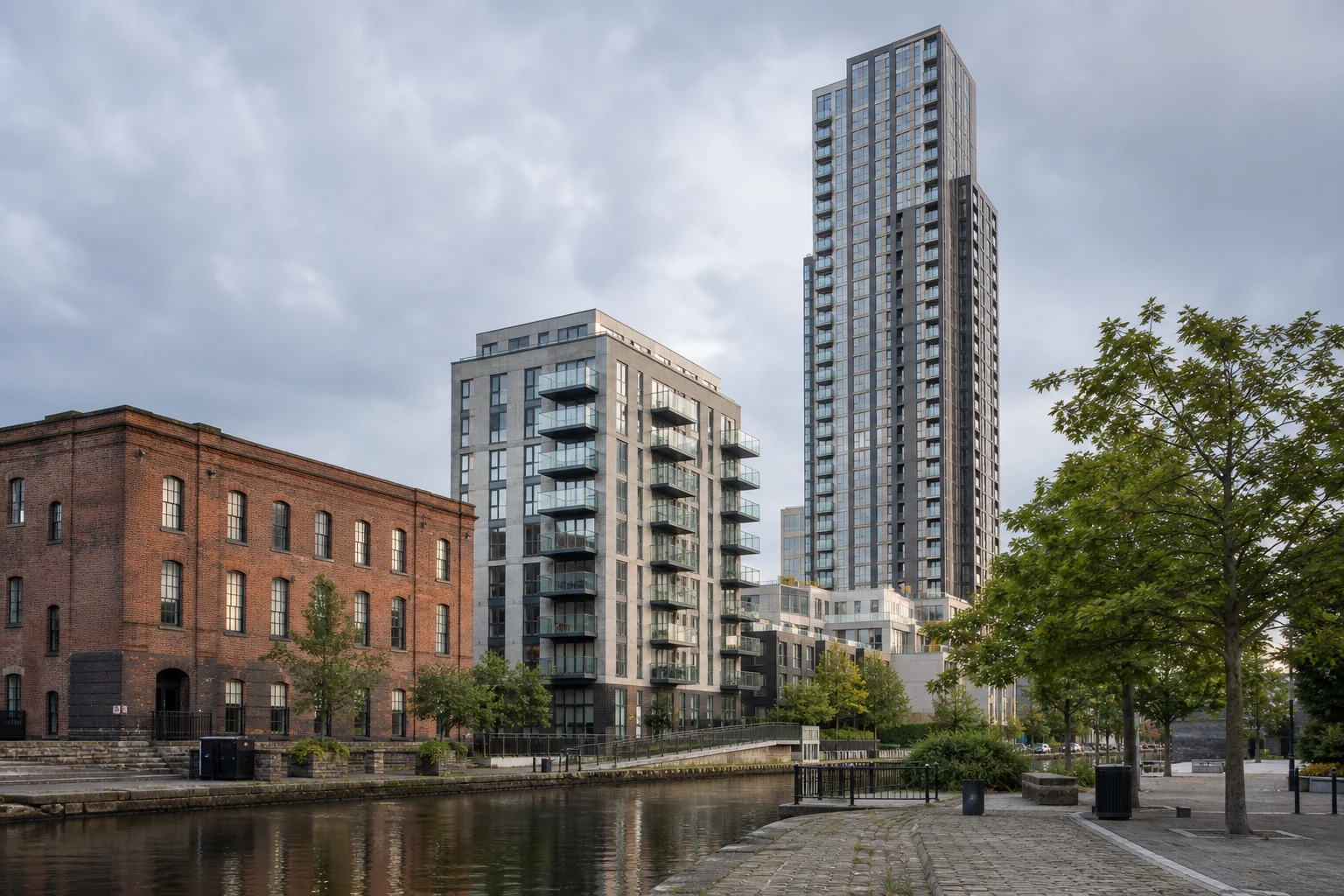 Proposed residential towers rising behind historic Manchester warehouse buildings